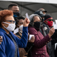 People show off their coronavirus vaccine record cards at Six Flags in Bowie, Maryland on February 6, 2021.